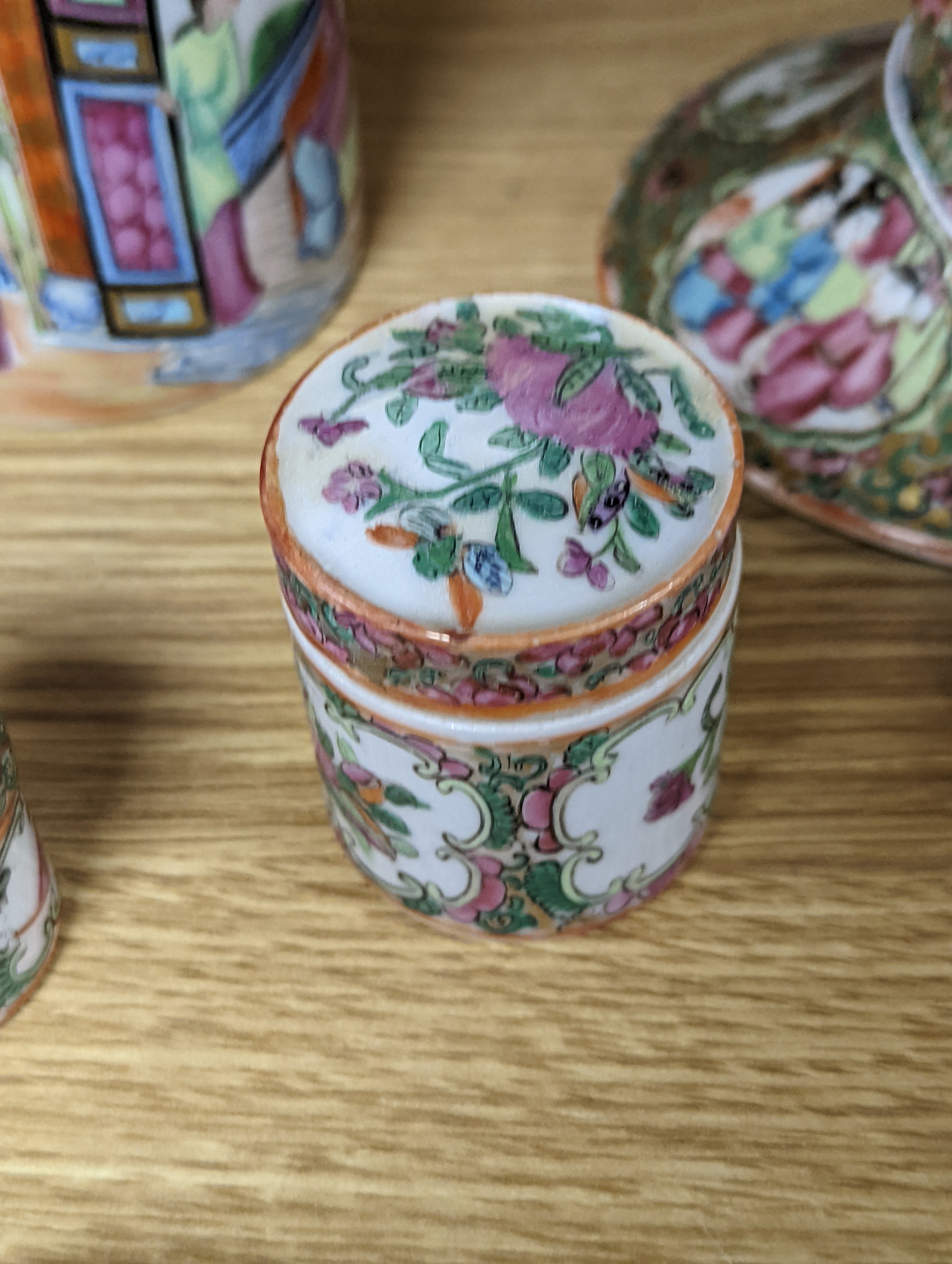 A Chinese Canton famille rose nest of boxes and covers, a similar candlestick and a tray 23cm